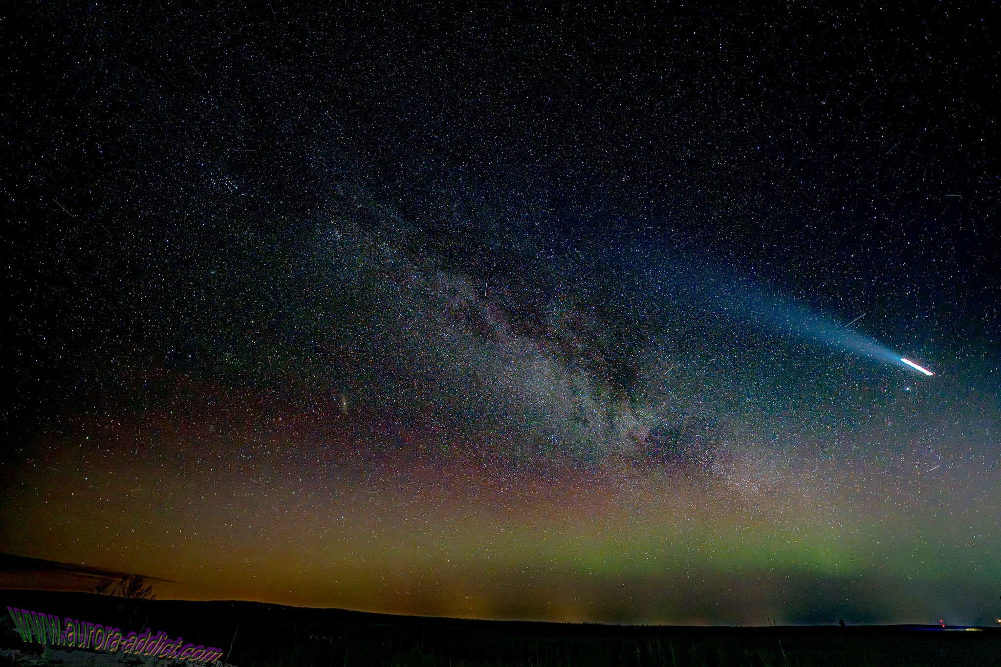 Plane taking off against Aurora and Milky Way